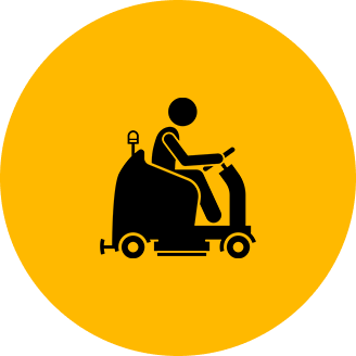Icon of a person driving a floor cleaning machine on a yellow circular background.